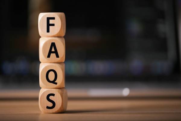 FAQS spelled using wooden letter cubes depicting CO alarm FAQs