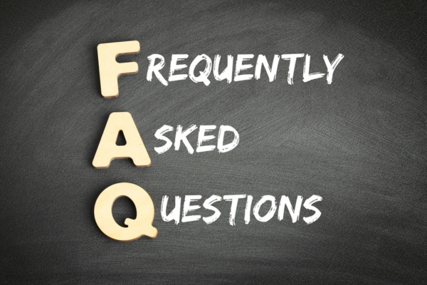 frequently asked questions written on blackboard using chalk and wooden letters