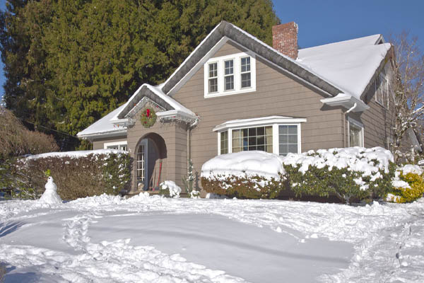 house in winter with snow depicting home heating oil and comfort