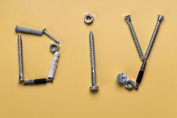 DIY spelled using different screws depicting DIY electrical repairs