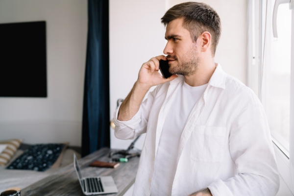 image of a man on the phone calling for oil delivery