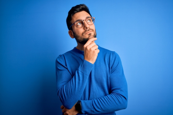 man looking up with hands on chin depicting thinking about will call and automatic oil delivery