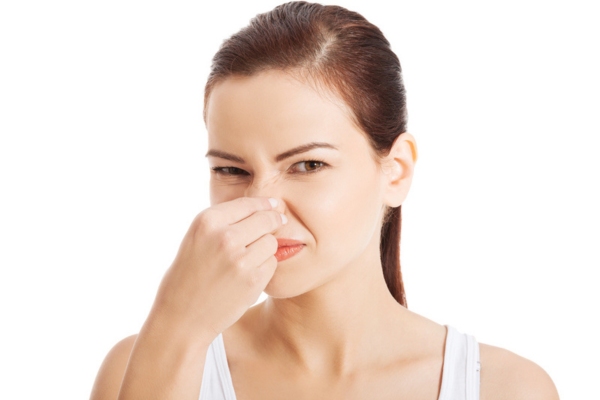 woman covering her nose due to burning smell depicting electrical system