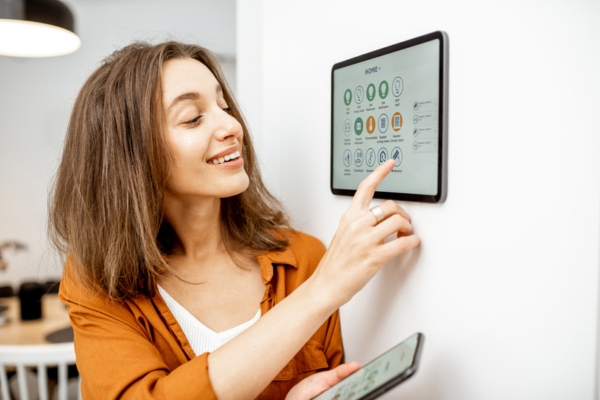 woman synching smart home control on her smart phone for convenience