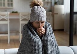 Unwell woman feel cold in home with no heating