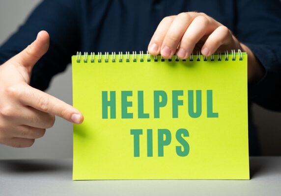 helpful tips written on a notebook shown by a cropped view of a mans hand depicting water softener