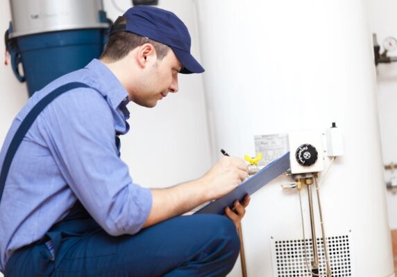 plumber inspecting a leaky water heater