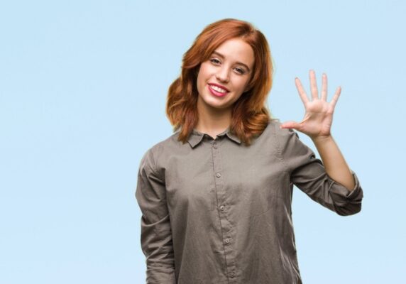 young woman holding 5 fingers up depicting signs you need an electrical upgrade